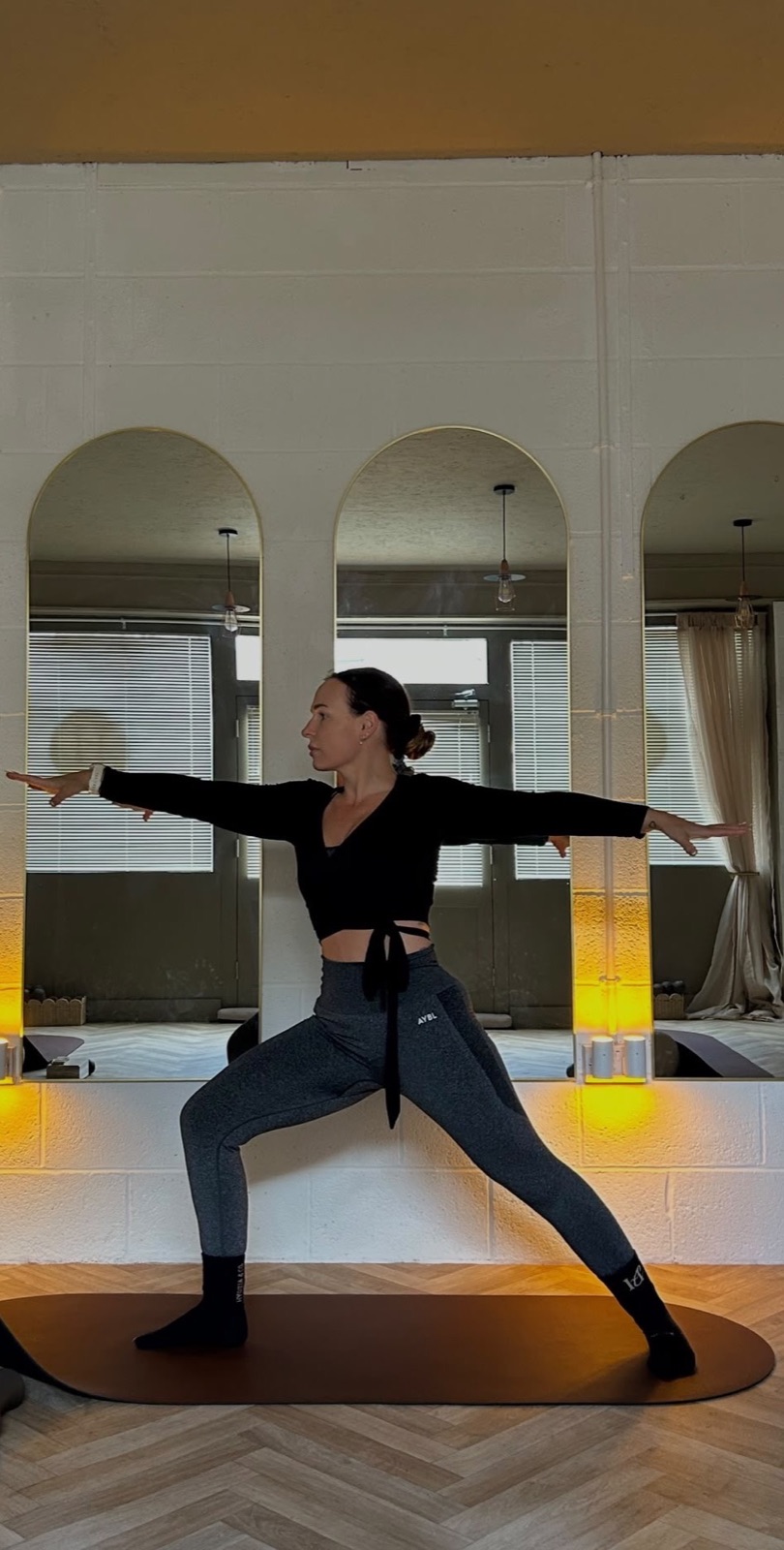Yoga in front of the arched mirrors